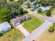 Aerial view of a light blue, one-story home, with a well-manicured front yard at 500 E Gottsche Ave, Eustis, FL 32726