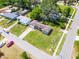 An aerial view of a charming single-story home with a lush green lawn at 500 E Gottsche Ave, Eustis, FL 32726