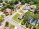 Aerial view of a residential area showcasing diverse homes and lush greenery at 500 E Gottsche Ave, Eustis, FL 32726