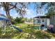 Large backyard with playset, shady trees and covered patio at 500 E Gottsche Ave, Eustis, FL 32726