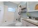 Bathroom with a shower-tub combination, updated vanity, and stylish shower curtain at 500 E Gottsche Ave, Eustis, FL 32726