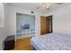 Cozy bedroom with hardwood floors and closet with shelving for added organization at 500 E Gottsche Ave, Eustis, FL 32726