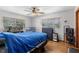 Comfortable bedroom with hardwood floors, two windows, and a ceiling fan at 500 E Gottsche Ave, Eustis, FL 32726