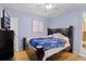 Bedroom with wood floors, ceiling fan, natural light, and access to bathroom at 500 E Gottsche Ave, Eustis, FL 32726