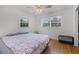 Bright bedroom featuring two windows and hardwood floors at 500 E Gottsche Ave, Eustis, FL 32726