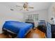 Bright bedroom with hardwood floors, ceiling fan, and large windows for natural light at 500 E Gottsche Ave, Eustis, FL 32726