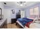 Inviting bedroom with ceiling fan, wood floors, and natural light at 500 E Gottsche Ave, Eustis, FL 32726