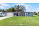 Charming single-story home with well-maintained lawn and stone chimney detail at 500 E Gottsche Ave, Eustis, FL 32726