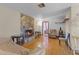 Cozy living room boasts a stone fireplace and hardwood floors at 500 E Gottsche Ave, Eustis, FL 32726