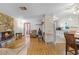 Spacious living room featuring stone fireplace and hardwood floors at 500 E Gottsche Ave, Eustis, FL 32726