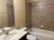 Bathroom features a bathtub with tiled wall and a shower head, a toilet, and vanity on the side at 5377 Via Appia Way, Sanford, FL 32771