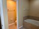 A bathroom with a bathtub and a toilet in separate sections at 5377 Via Appia Way, Sanford, FL 32771