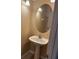 Elegant powder room with a pedestal sink and decorative oval mirror at 5377 Via Appia Way, Sanford, FL 32771