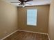 Cozy bedroom with wood-look flooring, a ceiling fan, and a window with blinds providing natural light at 5377 Via Appia Way, Sanford, FL 32771