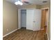 A bedroom with a spacious closet, wood-look flooring, and neutral paint ready for personalization at 5377 Via Appia Way, Sanford, FL 32771