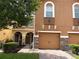 Charming townhome featuring a brick driveway, tan paint and stone accents on the garage at 5377 Via Appia Way, Sanford, FL 32771