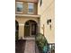 Charming covered entryway with a red door, decorative glass, and a brick walkway at 5377 Via Appia Way, Sanford, FL 32771