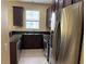 Well-lit kitchen featuring stainless steel appliances and dark wood cabinetry at 5377 Via Appia Way, Sanford, FL 32771