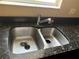 A stainless steel kitchen sink with granite countertops and a window for natural light at 5377 Via Appia Way, Sanford, FL 32771
