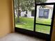 View from a screened lanai, with a grassy yard and trees visible at 5377 Via Appia Way, Sanford, FL 32771