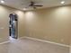 Bright living room featuring an open archway to the kitchen with stainless steel appliances at 5377 Via Appia Way, Sanford, FL 32771