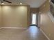 Bright living room with tiled flooring and a view of the decorative front door at 5377 Via Appia Way, Sanford, FL 32771