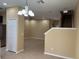 Open-concept living room with tile flooring, chandelier, and staircase to the second floor at 5377 Via Appia Way, Sanford, FL 32771