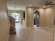 Open living room with tiled floors, staircase, and views to the kitchen and screened porch at 5377 Via Appia Way, Sanford, FL 32771