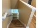 A staircase descending with wooden steps and a white handrail at 5377 Via Appia Way, Sanford, FL 32771