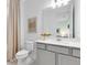 Clean bathroom with white vanity, framed mirror, beige curtain, and modern fixtures at 6014 Tree Crossing Ln, St Cloud, FL 34771