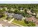 Aerial view of a gray home with driveway, large lawn and mature landscaping at 645 Macglenross Dr, Oviedo, FL 32765