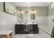 Bathroom showcasing double sink vanity, soaking tub, separate glass shower and wainscoting at 645 Macglenross Dr, Oviedo, FL 32765