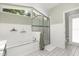 Bathroom featuring a soaking tub, separate glass shower and natural light at 645 Macglenross Dr, Oviedo, FL 32765