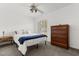 Bright bedroom with wood furnishings, window with plantation shutters, and plush carpet at 645 Macglenross Dr, Oviedo, FL 32765