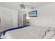 Clean bedroom featuring white walls, a mounted TV, and plush carpet at 645 Macglenross Dr, Oviedo, FL 32765
