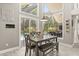 Bright dining area with modern table set and large windows overlooking the outdoor pool at 645 Macglenross Dr, Oviedo, FL 32765