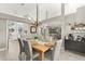 Bright dining space features modern decor, wood-look floors, and large windows, perfect for Gathering meals and entertaining guests at 645 Macglenross Dr, Oviedo, FL 32765