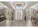 Grand entryway with soaring ceilings, wood-look floors, and abundant natural light, creating an open and inviting space at 645 Macglenross Dr, Oviedo, FL 32765
