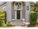Elegant front entrance featuring a decorative wreath, sidelights, and a well-manicured garden, offering great curb appeal at 645 Macglenross Dr, Oviedo, FL 32765
