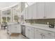 Well-lit kitchen showcasing white countertops and cabinetry, along with stainless steel appliances at 645 Macglenross Dr, Oviedo, FL 32765