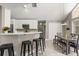 Inviting kitchen area with white cabinets, a breakfast bar, and a view of the dining area at 645 Macglenross Dr, Oviedo, FL 32765