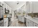 Modern kitchen featuring white cabinets, stainless steel appliances, and plenty of counter space at 645 Macglenross Dr, Oviedo, FL 32765