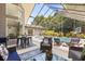 Inviting screened-in lanai with comfortable seating, outdoor dining area, and views of the pool at 645 Macglenross Dr, Oviedo, FL 32765