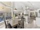 Bright open-plan living area with dining table, kitchen and direct access to a screened in lanai at 645 Macglenross Dr, Oviedo, FL 32765