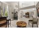 Bright living area showcases modern furnishings, a wet bar, and large windows, seamlessly blending style with inviting design at 645 Macglenross Dr, Oviedo, FL 32765