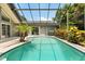 Screened in pool with turquoise water, tile trim and a small palm tree at 645 Macglenross Dr, Oviedo, FL 32765