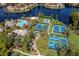 Aerial view of community with pool, tennis courts, and lake at 697 Broadoak Loop, Sanford, FL 32771