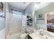 Bathroom featuring a shower-tub combo, updated vanity, and a decorative mirror providing a relaxing and functional space at 697 Broadoak Loop, Sanford, FL 32771