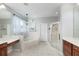 Bright bathroom featuring a soaking tub, glass-enclosed shower, and dual vanities at 697 Broadoak Loop, Sanford, FL 32771