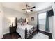 Bedroom features a dark wood bed frame, dark hardwood floors, and decorative lighting creating an inviting space to rest at 697 Broadoak Loop, Sanford, FL 32771
